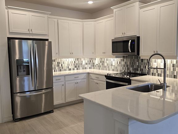 Designer Kitchen featuring upgraded stainless steel appliances and lower cabinets featuring premium pull-out drawers.