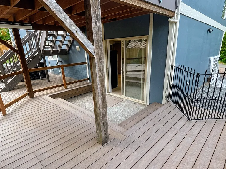 Fenced-in, covered deck. And the entrance of the apartment.