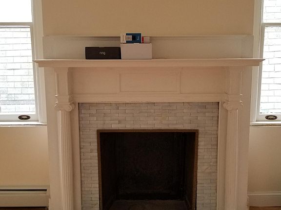 Two original fireplaces adorn the first floor of the duplex consisting of kitchen, living, dining and bathrooms and two bedrooms.