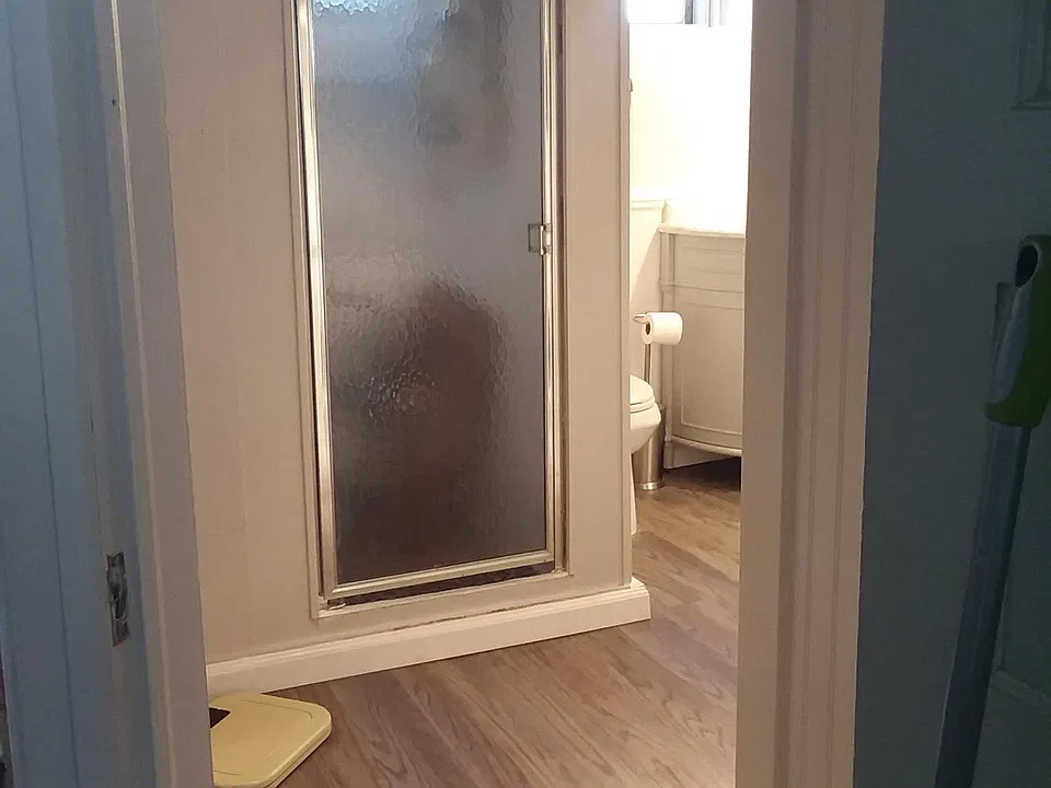 Bathoom entrance - stackable laundry, shower, maintenance room, sink/toilet.