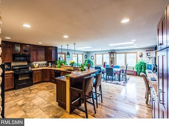 Large kitchen with granite counter tops, tiled kitchen floors, Cyprus hardwood floors in the eating area. Walk out to deck. New sky lights and windows.