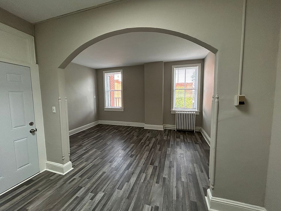 Large living room with arched entry.