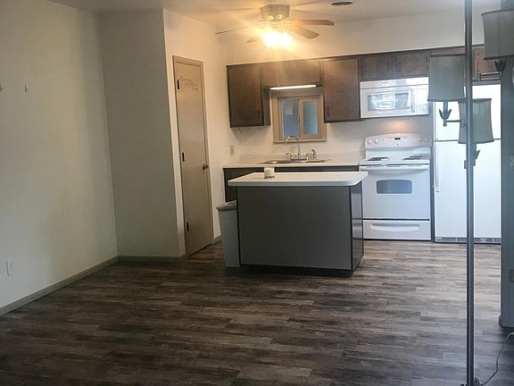 Living room looking into kitchen with moveable island large enough for 2 as an eat up bar.