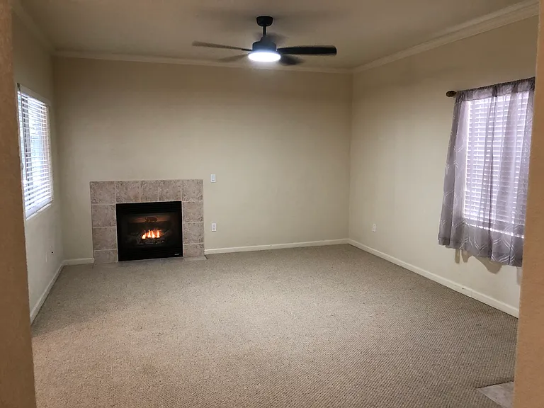 Large Living area. I had an 80" TV next to fireplace. Left window overlooks covered patio. Right window overlooks entrance area.