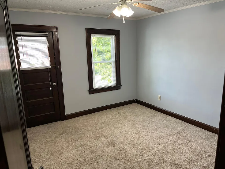 Bedroom with outside balcony and ceiling fan. Freshly painted.