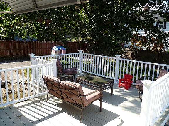 Spacious deck overlooking fenced-in back yard. 