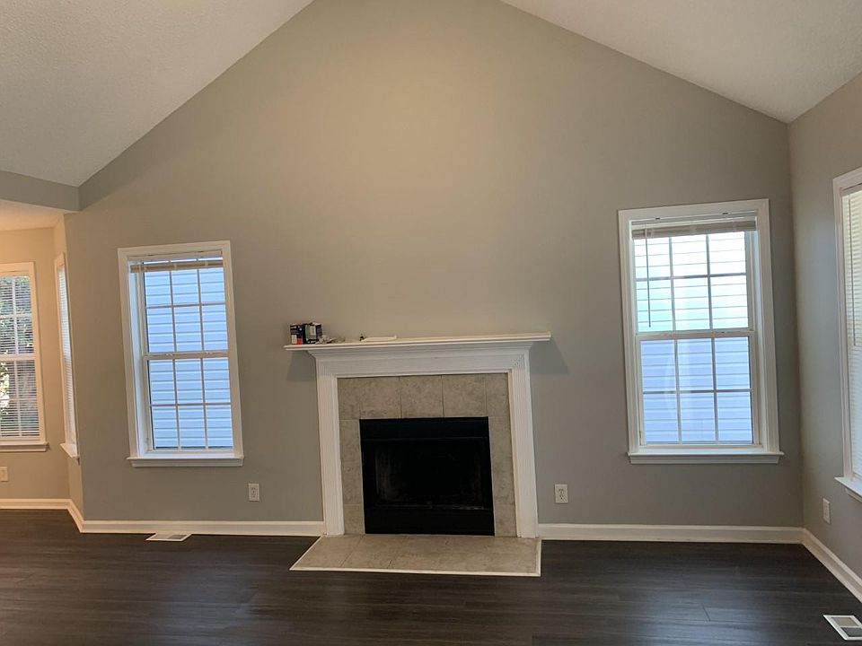 Large open area living room with cathedral ceilings and decretive fireplace