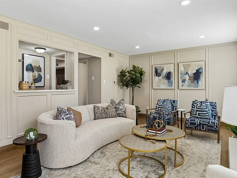 Living area featuring recessed lighting,paneling, & a pass-through window to the wet bar.