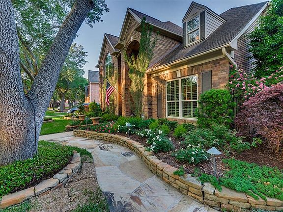 It's no surprise that this showplace has earned the coveted Yard of the Month Award multiple times! The entire perimeter of the home is lined with breathtaking Landscaping with Raised Flower Beds, variations of Flowering Plants, Illuminated Walk Ways