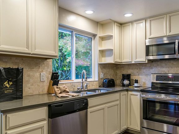 Beautiful kitchen with large window overlooking backyard