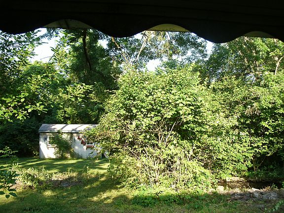 little pond and few  out buildings