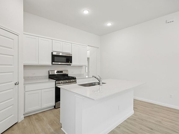 Kitchen in the Cypress home plan by Trophy Signature Homes - REPRESENTATIVE PHOTO