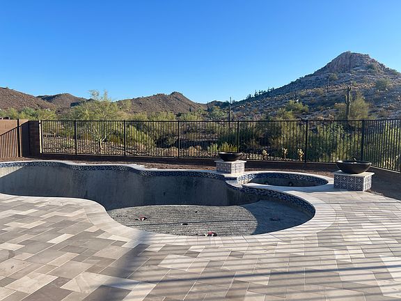 Stunning, private backyard! Expansive limestone patio, pool with baja ledge, fire bowls and built in spa. Electric and gas heat pumps so the hot tub can be heated independently. The final pool coating will be a beautiful deep blue color.