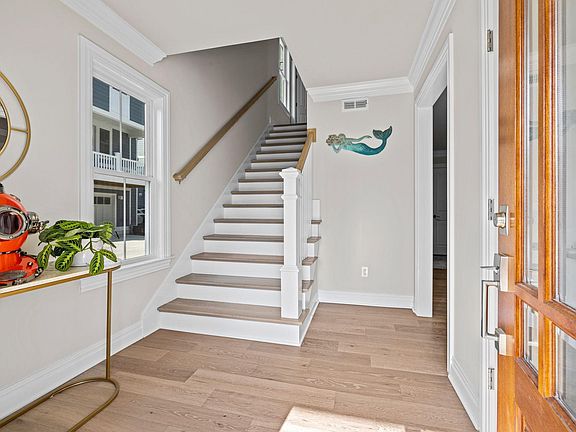 Entry Way and staircase up to living room, dining room, and kitchen.