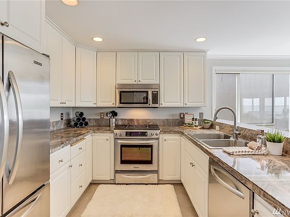 The timeless kitchen has new flooring, stainless steel appliances with gas range, granite countertops, a walk-in pantry and tons