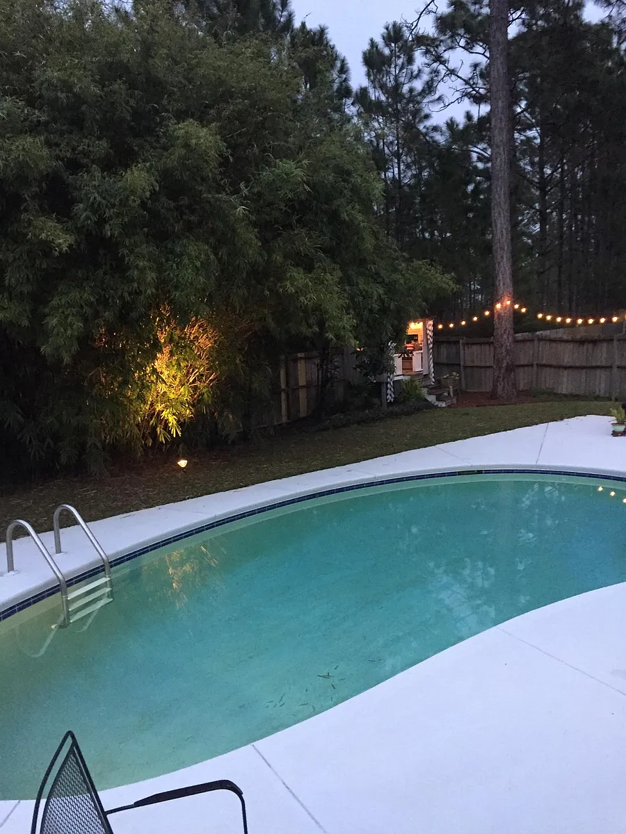 Pool at night with play fort in rear - 67 Albatross Ct