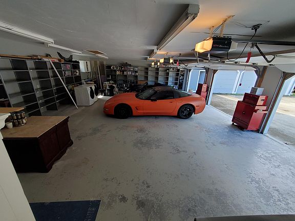 Massive 3 car garage with steel shelves