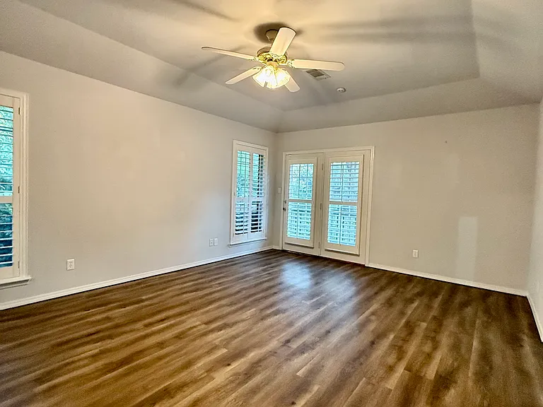 Primary bedroom with vaulted ceilings.