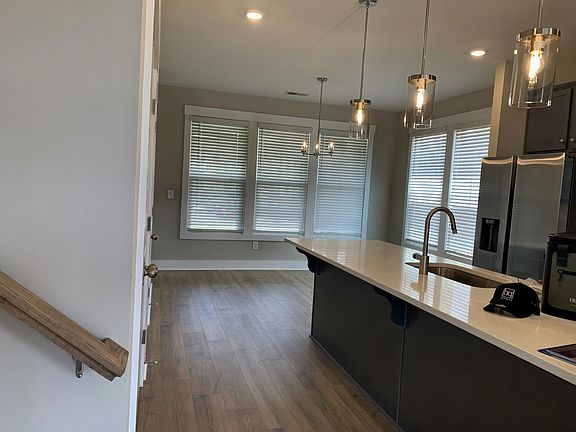 Kitchen - Refrigerator, Dishwasher, and Microwave. Exhaust fan vents out.