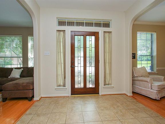 The glass panelled front door floods the home with light.
