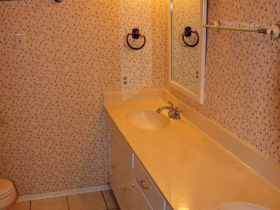 "Master bath with double vanity and tile floor"
