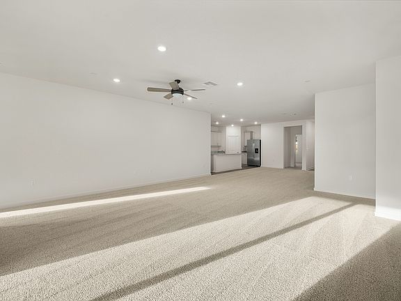 The family room is spacious with a ceiling fan.