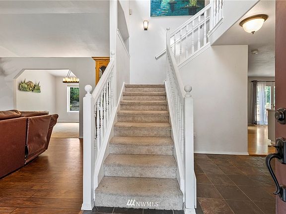 Large open Entrance with the living and dining rooms to the left and kitchen to the right. 