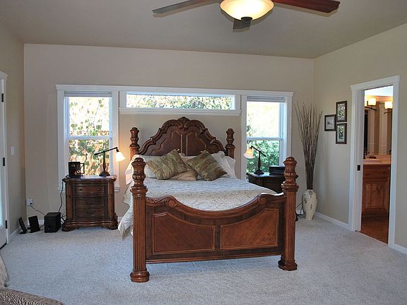 Master Suite with gas fireplace, access to back patio, and bathroom