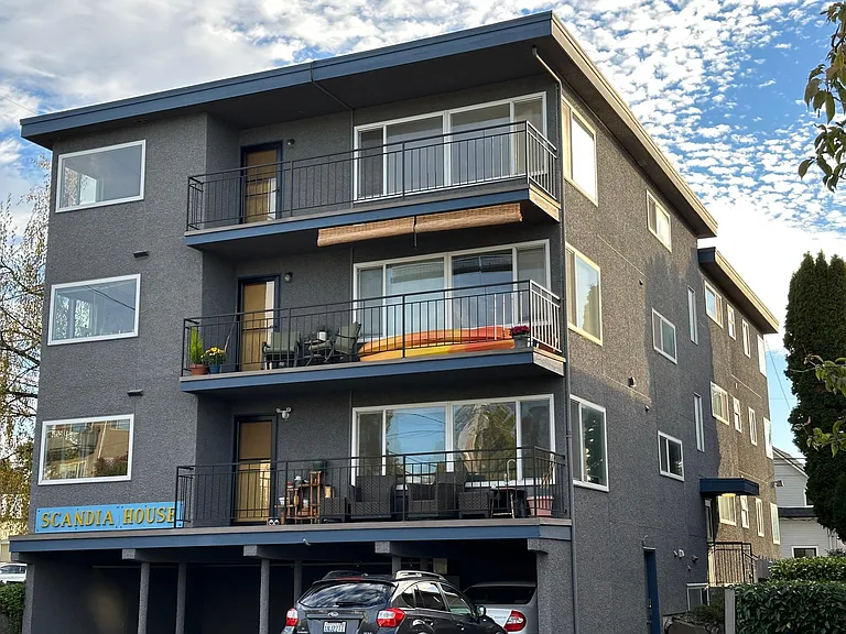 Building from the west. Available unit is the top floor. Covered parking bottom left.