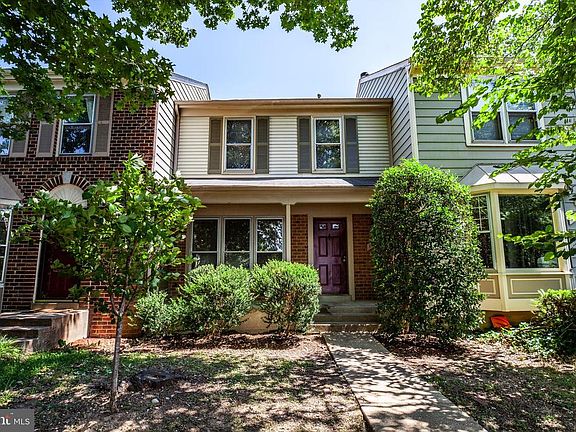 The home is nestled among trees in front and back.