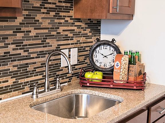 Experience elegance in this thoughtfully designed kitchen corner featuring modern amenities and charming decor.