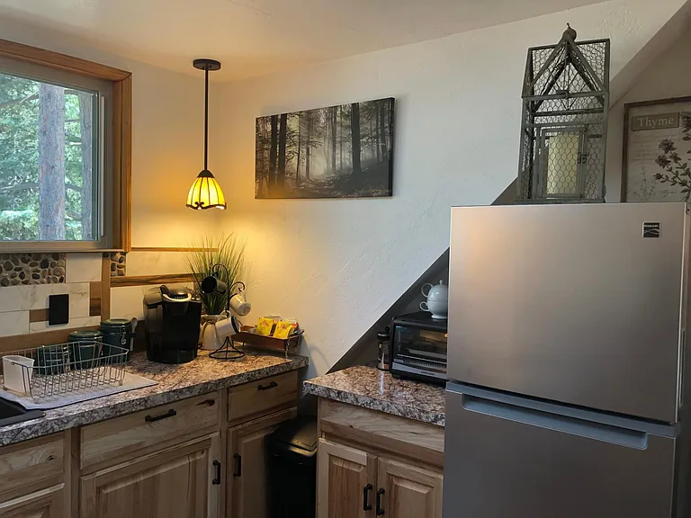 The microwave is underneath the dish drainer.