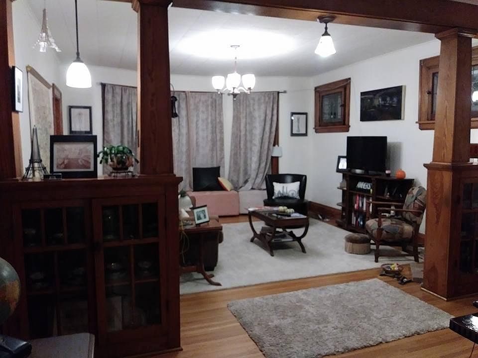 Entrance to living room has built in china cabinets