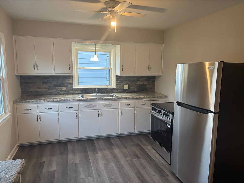 Kitchen with brand new stainless steel appliances and ceiling fan.