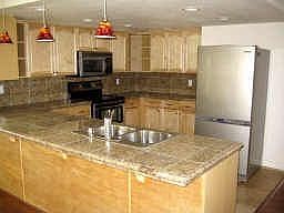 Granite Countertops, Stainless Steel Appliances and Travertine Tile!
