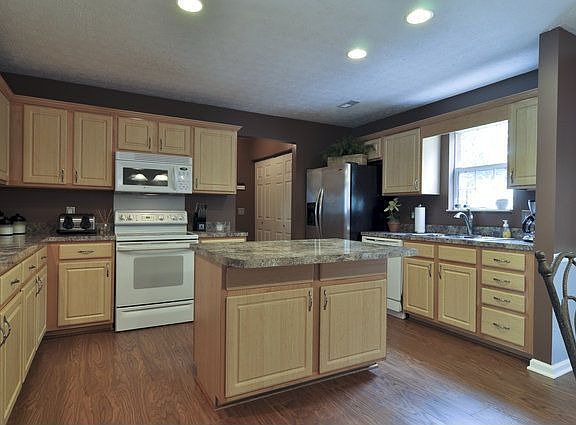 Kitchen has a pantry and lots of cabinets.