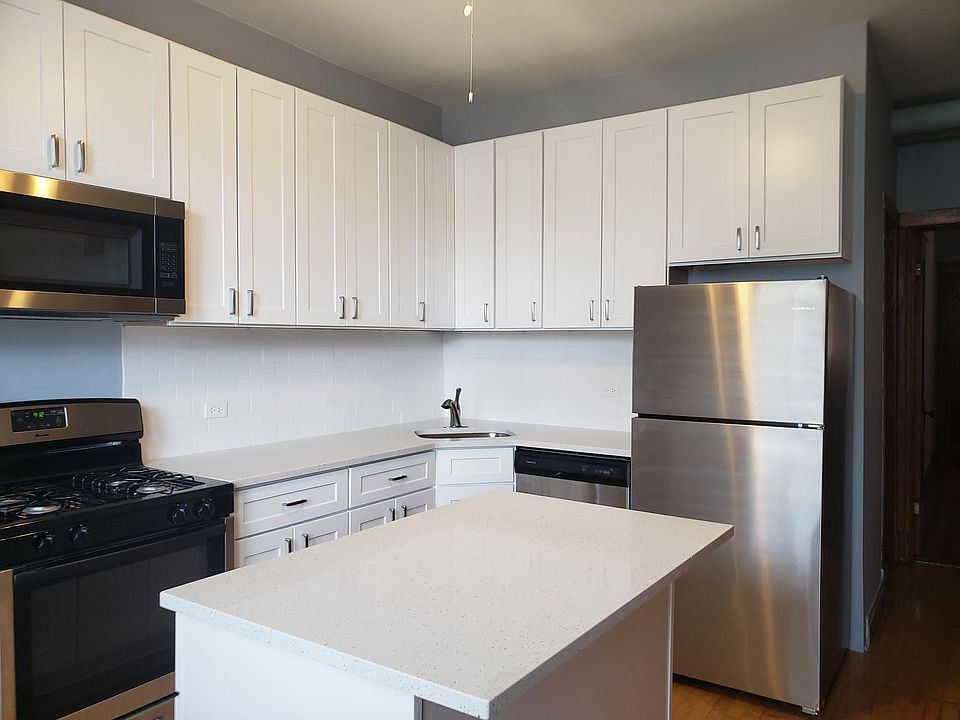 new kitchen with island and quartz countertops