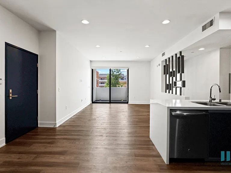 Front Entrance and Open-Concept Kitchen, Dining, and Living Room Space with Patio