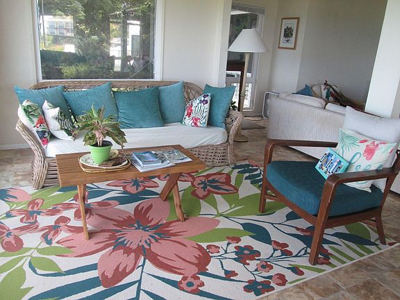 One of three living room seating areas, each has a full length couch