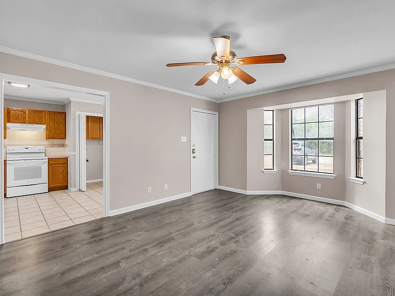 Open concept living area with beautiful bay windows and lots of natural light.