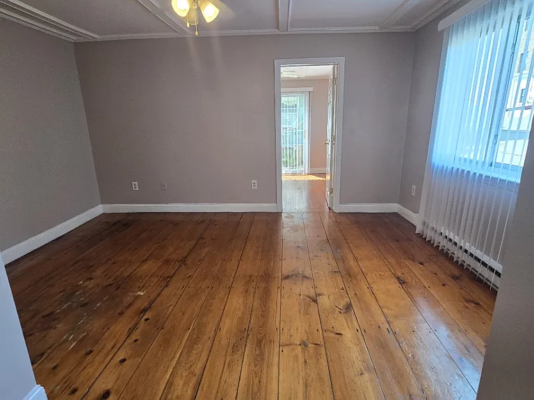Living room looking into back bedroom