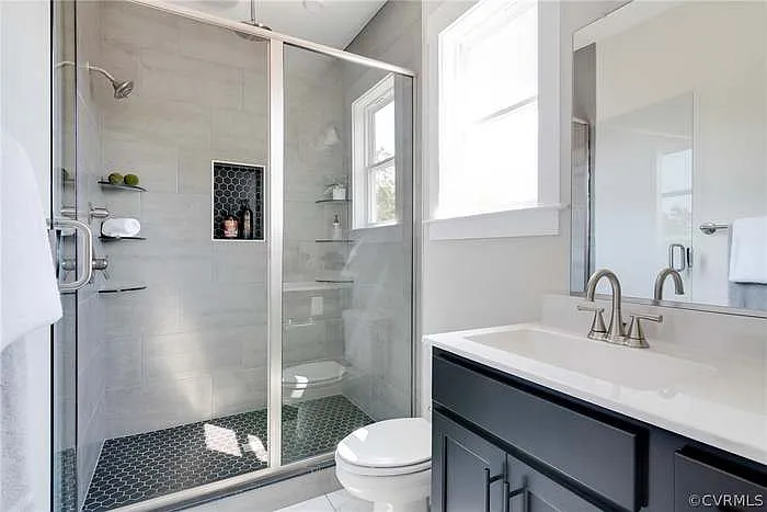 Primary bathroom, double vanity and walk-in shower.
