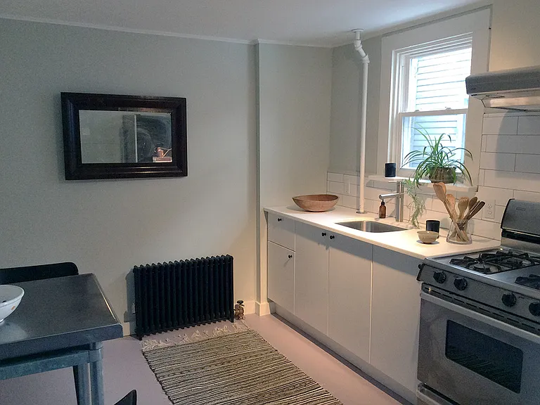Kitchen with linoleum floor, corian worktops, new range, vented hood, refrigerator/freezer