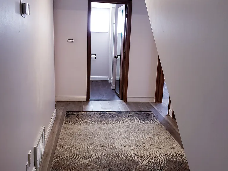 Large hallway to bedrooms and laundry.