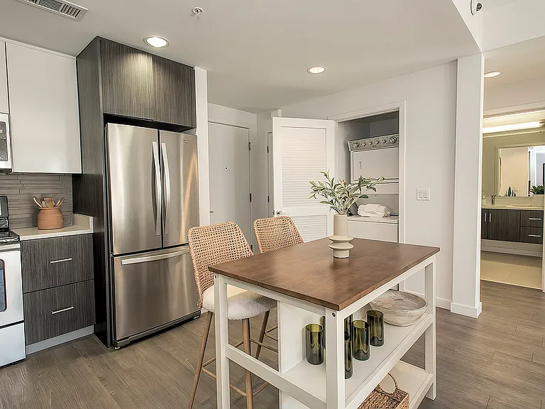 Open kitchen with premium finishes, stainless-steel appliances, and breakfast bar seating.