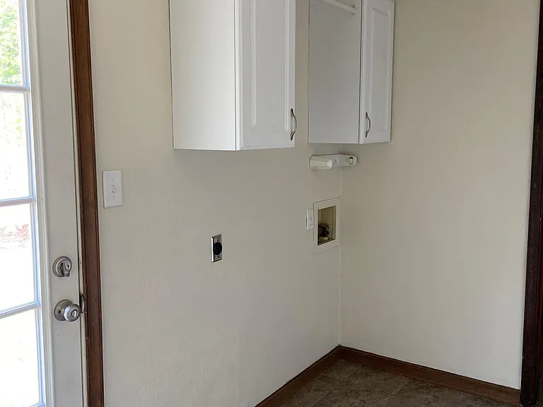 More laundry area with a nice place to store supplies and hang your clothes.