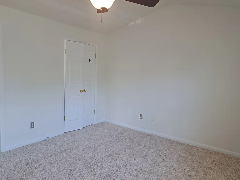 Master bedroom view showing the closet doors -- the closet is large as can be seen by the double doors