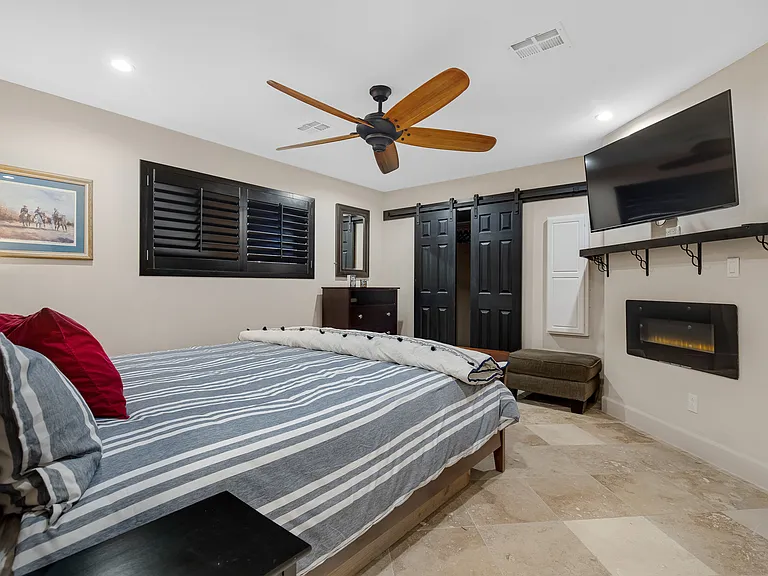 Private bedroom with electric fireplace.
