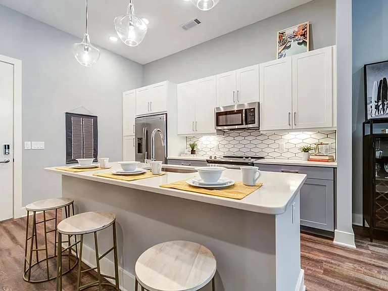 Modern Kitchen with Slab-Front Cabinets, Quartz Island, and Stainless Steel Appliances