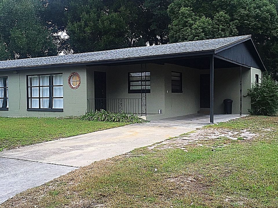 Front of property - private carport and driveway